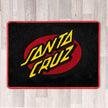 Large rectangular floor rug with Santa Cruz logo shown in black carpet with yellow carpet logo