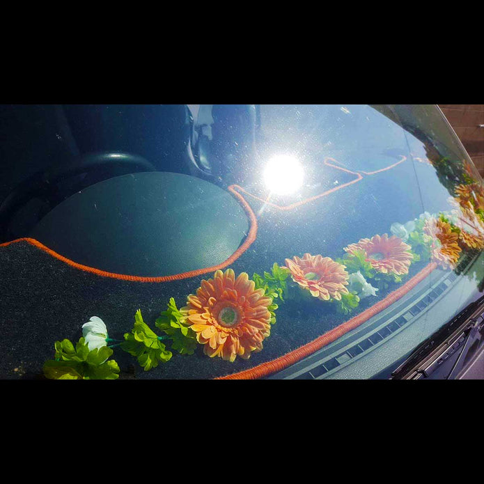 T5 dashboard mat shown in black carpet with orange trim