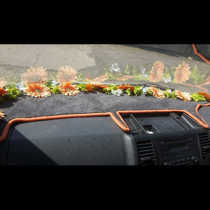 T5 dashboard mat shown in black carpet with orange trim