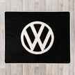 Large rectangular floor rug with VW circle logo shown in black carpet with white carpet logo