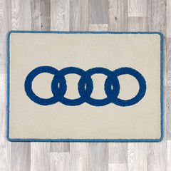 Rectangular rug with Audi logo in blue and cream colours
