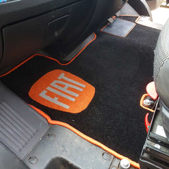Fiat van cab rug shown in a van with black carpet and orange binding