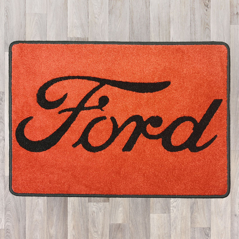 Rectangle floor rug shown in red with black trim and ford logo