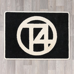 Rectangular rug with T4 logo in black and cream colours