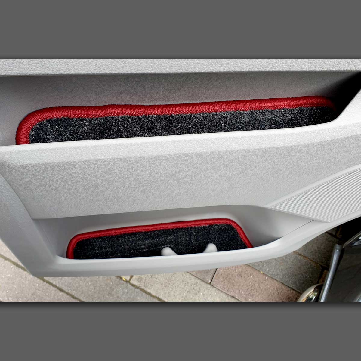 T5 door pocket liners shown in door pockets, in grey carpet with red binding