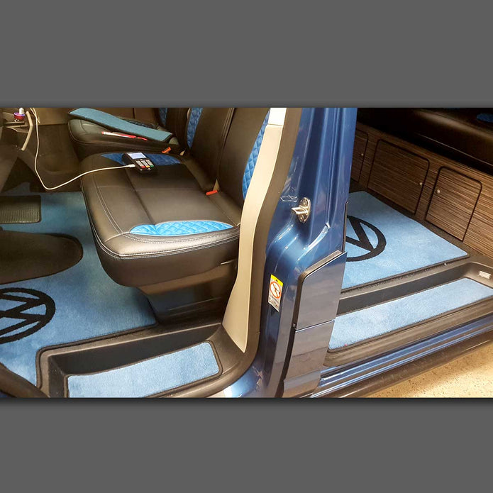 T6 mat set shown inside a T6 van. Includes cab mat, side steps and living area rug in blue carpet with black binding.