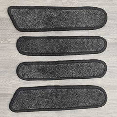 T6 Transporter door pocket liner mats shown in dark grey carpet with black binding.
