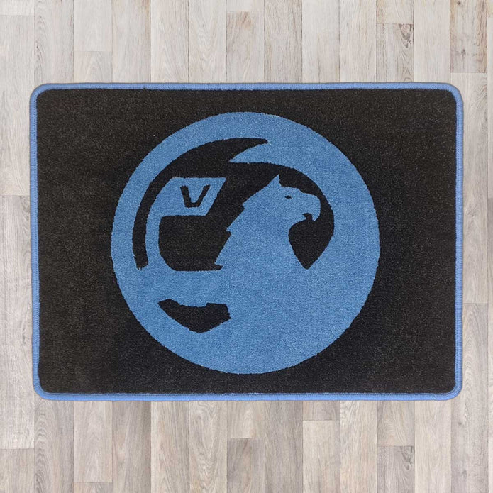 Vauxhall rectangle floor rug shown in black carpet with blue binding  Edit alt text